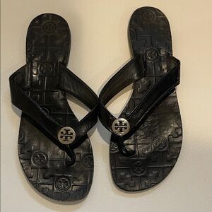Tory Burch Thora Glossy Black Flip Flops with Silver Emblem